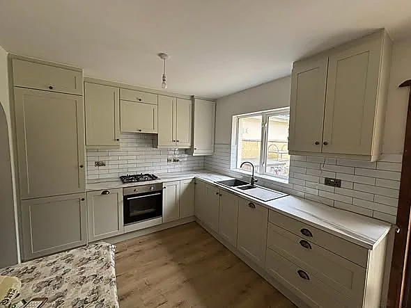 Compact sage green fitted kitchen by Downes Fitted Furniture